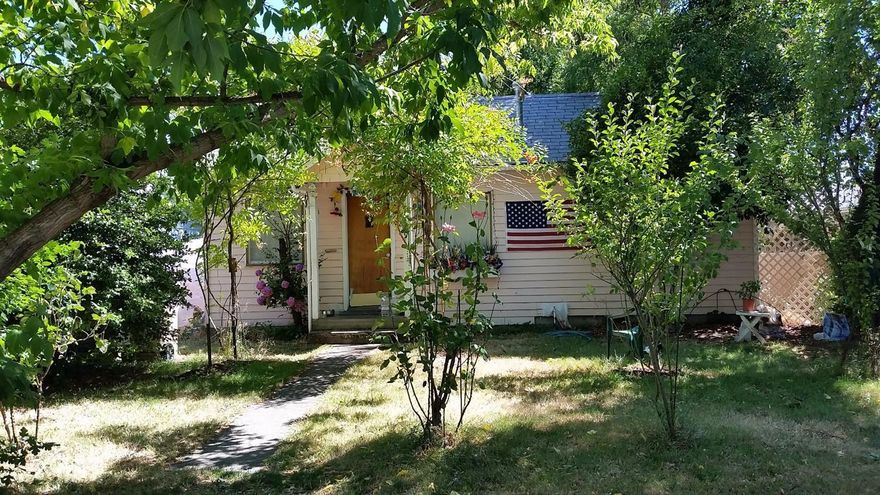 Priced right for the person needing storage space and a large shop. Multiple sheds plus shop in the backyard. Washer/dryer located in back screened in patio. Kitchen can accommodate electric or gas appliances. Cozy inside with nice sized living room and master bedroom. Convenient location - just minutes from downtown shopping and restaurants. Fruit trees in front and back plus areas for your gardening needs. Alleyway access.