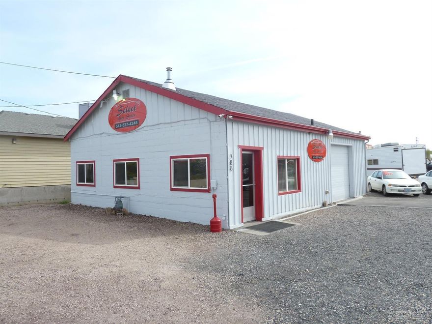 High visibility and access on both 5th and 6th ST. Paved drive and rock parking lot. All NEW paint inside and out, new trim, gutters, security system, tile bathroom, carpet, leveled floor and textured the office. Building has heated shop area and office space, a large sliding door connects the two.