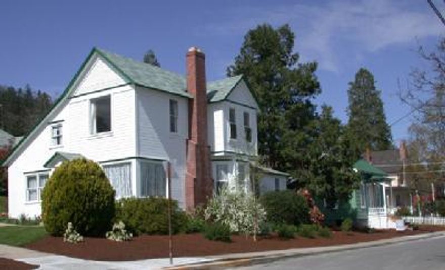 Two vintage homes on one lot: 103 S. Laurel St was built in 1900, has 1882 SF & 3 bedrooms/3 baths. Outside entrance/stair still accesses former separate unit upstairs, but inside entry also. New gas furnace w/ac here. 203 High St was built in 1870's & recently moved to this site from 99 Granite St., has 749 SF, 2 bedrooms/ 1 bath. Two detached garages/storage/workshop bldgs. Nice landscaping with beautiful mature plants, some not visible until spring. Only blocks to downtown Ashland.