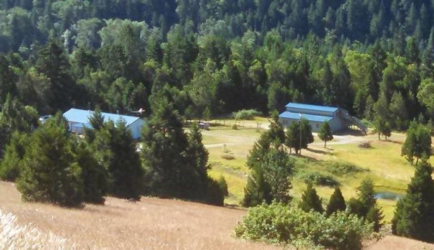 A Homestead of 44 acres of privacy, mtn & valley views! This remodeled Ranch home features 3 bdrm and 2 full bath and is ready for you and your pets. The home has been lovingly cared for and is simple and eloquent, while living gently on the land. And don't miss the covered patio for entertaining friends & family. Large picture windows accent the mtn & valley views, you feel like you are on top of the world! There are ponds, springs, and a well for your water needs and wildlife that is attracted to this site, so look for the deer, raccoon, and western bluebirds. A large 2 story workshop with equipment carport, and a ton of storage room upstairs, includes a drive thru main level for tractors, atvs or cars. Then there is a good size detached garage/shop, garden, and so much more. ...and a second site to build caretakers home with its own well! This home is just minutes east of the Seven Feathers Resort & Casino, in the quaint town of Days Creek.