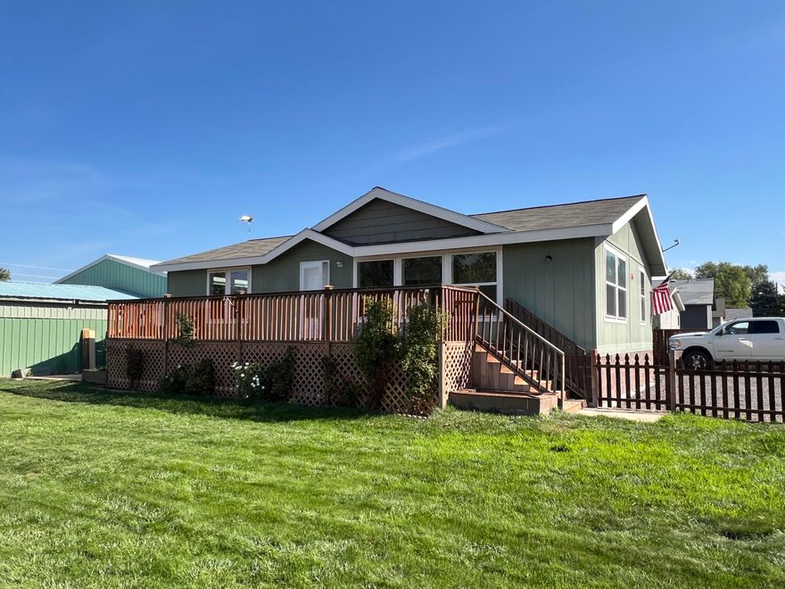 Home in town with a large shop! This 1,188 sf, 2 bedroom, 2 bath home on a .26 acre lot in town offers an open concept living area, tons of natural light, and a split bedroom floor plan. Enjoy the convenience of in town living with 1,080 sf insulated shop with attached carport; in addition to a large fenced yard with plenty of space for gardening, pets or outdoor entertaining.