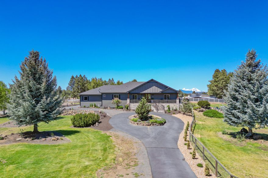 Stunning SINGLE LEVEL home on 4.53 acres with CASCADE VIEWS and 3 acres of IRRIGATION RIGHTS!  Open floor plan with vaulted ceilings, kitchen w/island and large dining area.  Custom finishes include mahogany front door, built-in entertainment center w/Montana stone gas fireplace, Acacia wood floors & quartz counter tops. Primary suite has attached sunroom/office/exercise room w/door to covered deck.  Primary bath has new tile shower & tub surround, vessel sinks & tile floors.  Seller has added wrap around composite deck with custom railings, front stonework, new roof and exterior paint in 2021 & more!  Attached 4 car garage with one bay used as exercise room w/ductless heat/AC.  1440 SF SHOP w/13' doors to store RV, dedicated 220 AMP meter & there is an outdoor RV area w/electrical hookup perfect for guests.  Fenced Orchard w/many fruit trees, underground sprinklers, pond, animal shelter/chicken coop & parcel is fully fenced.  Avion water and natural gas.  Zoned MUA10 w/room for ADU!