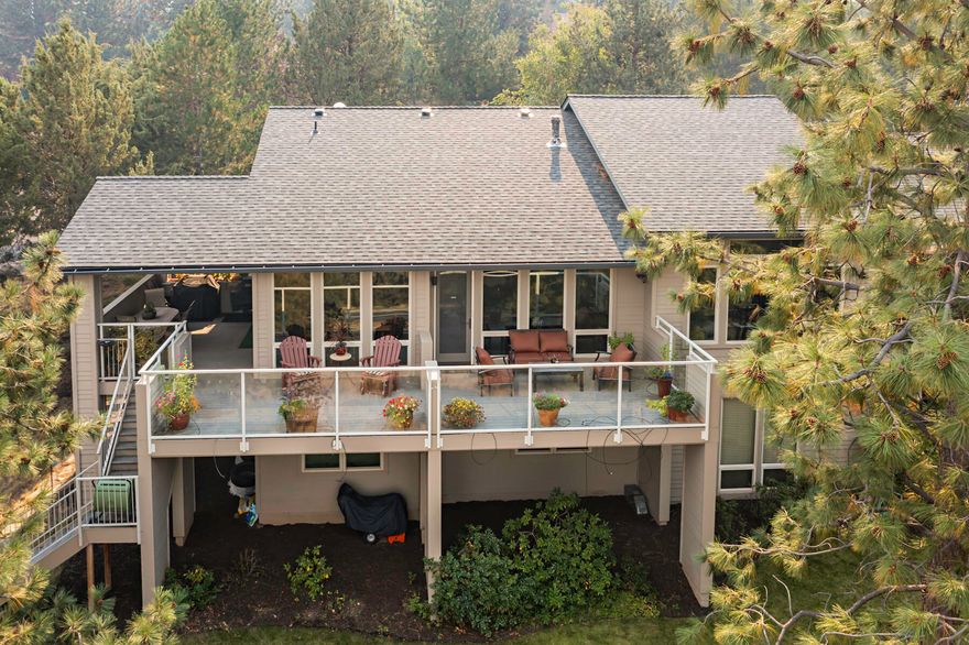 Breathtaking Cascade Mountain views frame this meticulously maintained, custom-crafted home on Awbrey Butte in NW Bend. Designed for high efficiency and comfort, it features radiant heat, eco-friendly solar panels, and countless upgrades—all priced well below replacement cost. The expansive great room showcases vaulted ceilings, a cozy gas fireplace, and built-ins that extends to the chef's gourmet island kitchen with granite countertops, stainless appliances, and a sunlit dining area. The spacious main level primary suite offers a luxurious private bath with jetted tub, tiled shower, and walk-in closet. A private study with elegant built-ins adds both charm and convenience. The lower level includes a versatile bonus room & a sun-soaked sunroom perfect for hobbies and relaxation. Enjoy the serene .87-acre setting with mature landscaping, towering pines, and an extensive main level deck ideal for outdoor living and unwinding after a long day. Call your broker for a personal tour today.