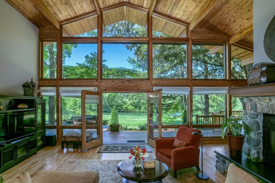 Applegate River frontage property! Come home to the True Oregon Riverfront Dream. This is a gorgeous Lindal Cedar Post and Beam home built in 1999, with a very open and light floorplan with 22 foot ceilings and walls of windows. The large 1200 sq ft deck off of the kitchen and living room is open to the river views and it perfect for entertaining family and friends. The spacious master suite is beautiful with an extra deep soaking tub, travertine floors, and marble inlay in the shower. The gourmet kitchen has a large island GE Monogram refrigerator, Jenn-Air double ovens and Jenn-Air gas range (replaced in 2016). There are wood floors throughout, four large bedrooms, two and a half baths, 3668 sq ft, and on 3.15 fully irrigated acres. There is a great barn for the horse lover, or hobby farmer, and the front pasture is fully cross-fenced. This home has captured magnificent views from almost every window. Conveniently located 13 minutes to Jacksonville and 25 minutes to Medford.