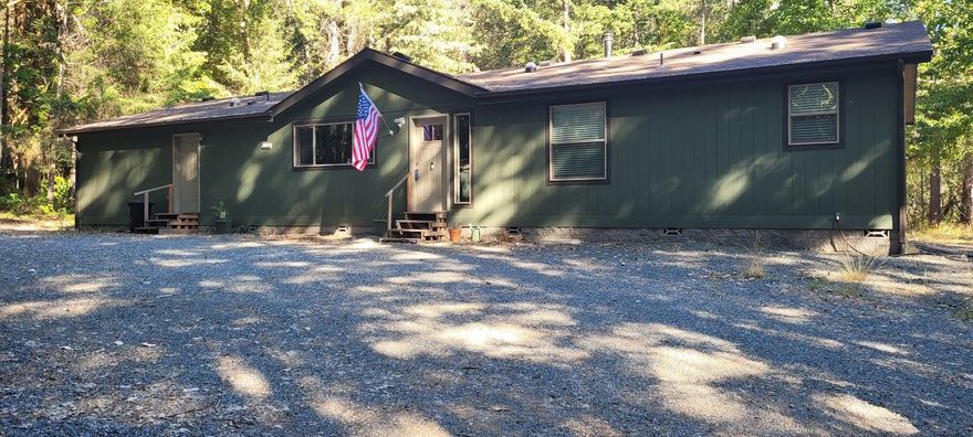 Welcome home to a fantastic opportunity to own a beautiful 2023 Manufactured home with custom upgrades. Property setting is tranquil and private located amongst a forest of trees with natural landscaping on 2.88 acres just minutes from town. Well-designed split floor plan along with open concept living for family gatherings or entertaining around the wood burning stove. Kitchen design with abundance of storage and counter space for those special occasions. A Large tuff shed with skylights for additional storage for those detailed projects. And what about the years old beautiful Cherry tree that adorns the property?  A fabulous addition to the natural wonders of this property.  Living Rural with a local hospital and medical 15 minutes away, shopping is 10 minutes away and 15minutes to the freeway entrance to I-5.