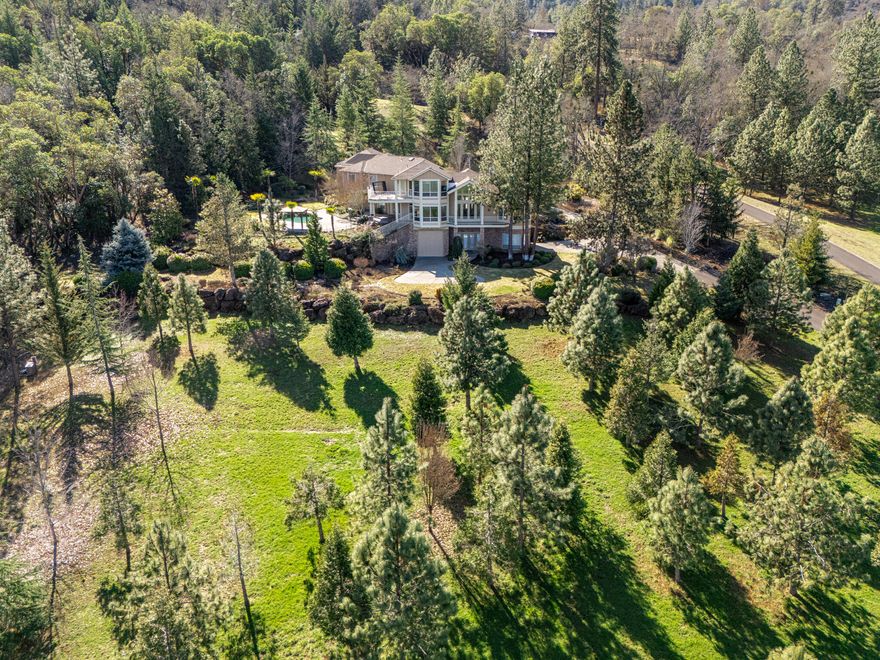 Nestled on 6.74 acres just outside Central Point, this private estate offers stunning views, exceptional amenities, and a great neighborhood. Minutes from Jacksonville, it blends space, luxury, and convenience. The expansive home is perfect for multi-generational living, with room for extended family, guests, or a game/bonus room. A 10-car garage with a workshop is ideal for car enthusiasts or hobbyists. The well-maintained property provides a peaceful retreat while remaining close to town. Enjoy the inground pool, perfect for relaxation and entertaining. Additional features include RV parking and a gated private entrance for security and privacy. Located in a welcoming community, this estate is in a highly desirable area known for its charm and tranquility. With ample space, breathtaking surroundings, and a prime location, this home is a rare find. Whether you're seeking a family retreat, investment opportunity, or dream home, this property is truly exceptional.