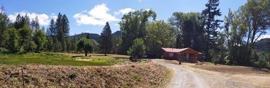 Southern Oregon 15 ac ranch. Water rights established 1862 from Pleasant Cr. for 8 irrigated acres. Zoning Exclusive Farm Use. Driving in gated entrance you are greeted by beautiful gable covered front porch made from hand sawn cedar timbers.4 bedroom 2 bath home, remodeled 2014,4th bedrm/office, Great room design. Kitchen features butcher block, center island,soft close drawers for storage of dishes, pots & pans.Spacious soapstone counter top with deep farm style sink and subway tile back splash. New custom cabinets. Pot filler faucet above gas range. Tile floor. All appliances stainless steel, dishwasher, trash compactor, range refrigerator/freezer. Walk in panty has ample storage. Large master suite with master bath and walk in closet.Access to covered porch overlooking open meadows and woods.Three other bedrooms & bath complement balance of home. Energy saving features include tank-less water heater and Lopi wood stove. Carport. Detached garage, Pole barn.Pond for irrigation