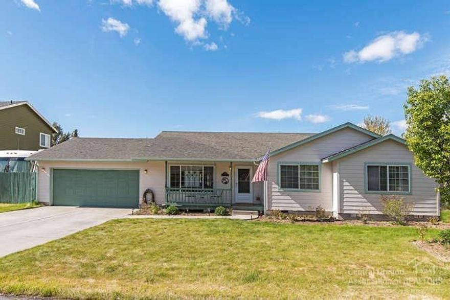 Easy living in this beautifully kept single level home in Stonebrook. Inside features newer acacia hardwood and tile flooring, open-concept layout, spacious 3 bedrooms, 2 bath w/ addt'l office and A/C. Attached 2-car garage with RV storage on side yard. Cozy front porch and paver back patio with fruit trees & established landscaping. Neighborhood gravel path and common area in your back yard offers lots of elbow room.