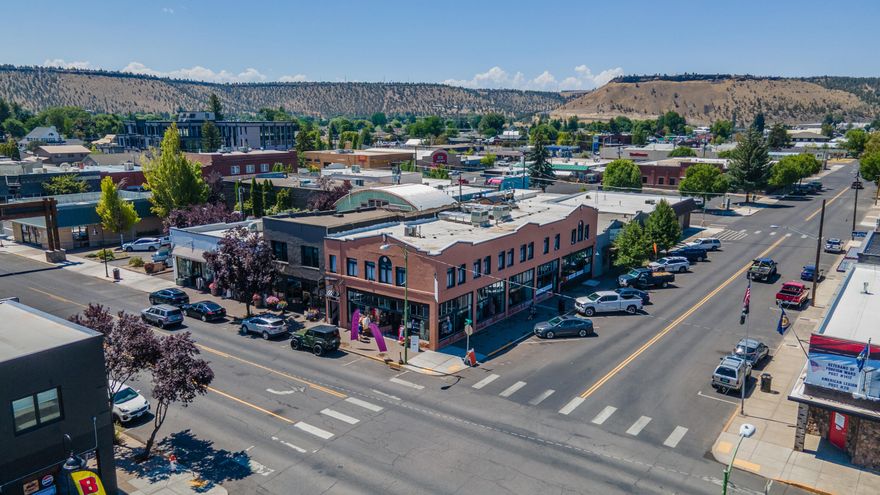 Iconic downtown Prineville building in the heart of Oregon's fastest-growing county. With 83% income growth and state-leading GDP gains, Prineville leads the region with unprecedented economic momentum.
Street-level retail is leased to Whiskey Darlin' boutique, a tenant since 2021, and HIIT Logic Fitness, both under new 3-year terms.
The upper level features a 12-room bunkhouse/extended stay motel, designed to serve the area's booming data and renewable energy sectors. It remains consistently occupied, with several long-term tenants contributing to strong, reliable cash flow. Not subject to Oregon's Residential Landlord and Tenant Act (ORS Chapter 90).
The property has been substantially renovated over the past 3 years, enhancing both its appeal and functionality. An unfinished basement offers additional upside for storage or future build-out.
A rare opportunity to own a landmark, mixed-use asset with a strong operating history and creative potential. Owner-carry terms available.