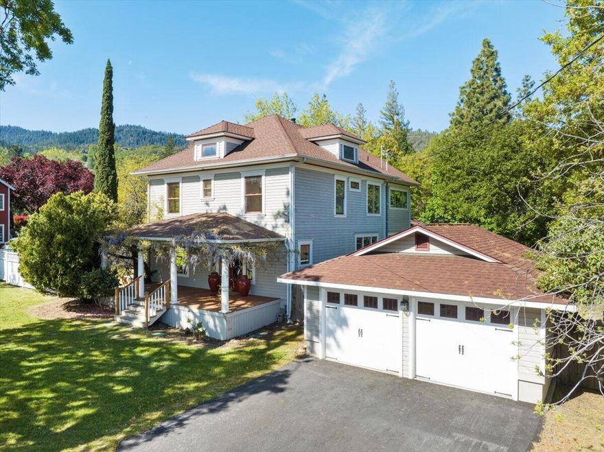 Historic charm meets modern luxury at this lovingly remodeled Ashland farmhouse. Original fir flooring and American plaster walls blend seamlessly with high-quality updates. Large wood-framed windows make the interior light and bright. A woodburning fireplace with custom Art Deco tile surround and hearth warms the living room. A breakfast bar and sunny dining nook overlooking the patio invite friends and family to linger in the huge open kitchen. The family chef will appreciate the professional-grade grade appliances, granite countertops and custom cabinets and lighting. Upstairs, the primary suite is a tranquil treetop retreat with a luxurious bath. Three additional bedrooms offer versatility. An attached mother-in-law unit with a separate entrance, skylights, and deck overlooking the seasonal creek provides flexibility. With .34 acres of irrigated land, fenced gardens, and proximity to amenities, you'll find the best of country and city life at this beautiful Ashland home.