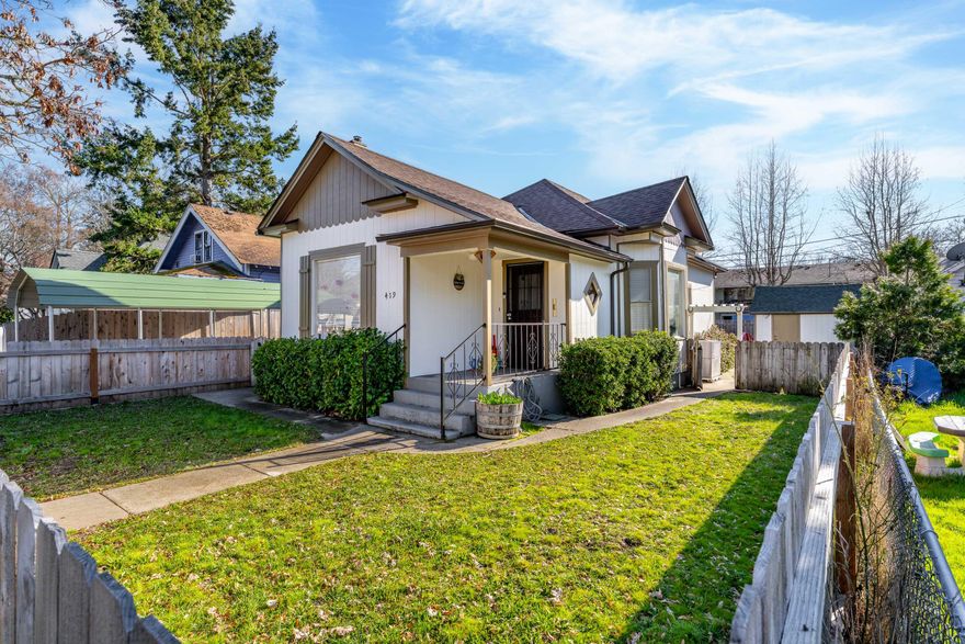 Step into the charm of this beautifully updated 1890-built home where timeless character meets modern comfort! This inviting residence features numerous upgrades (per seller), including a new roof, sewer line, fresh interior & exterior paint, new flooring, updated countertops, and newer appliances—all completed in 2022. Additional improvements include a new AC unit, bathroom vanity, fencing (2023), & updated insulation for year-round efficiency. Enjoy a cozy gas fireplace, back patio, & covered deck perfect for outdoor living. The property also offers a metal carport, detached single-car garage with alley access, & a 12x13 shed with power & heat—ideal for a workshop or extra storage. Move-in ready & full of charm! Buyer to perform their own due diligence regarding all aspects of the property, including zoning, permits, condition, & intended use. This property is now listed as a short sale and is contingent on seller's lender approval.