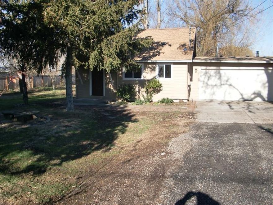 Wonderful opportunity to enjoy the peace and quiet of the country, just minutes from down town. This property offers enough space for gardening and growing as well as entertaining! The privacy fence and the location on a street with very little through traffic makes this a tranquil setting for a family or those who enjoy some seclusion. The home has been completely updated with beautiful granite counter tops, recent new flooring and paint. The open floor plan works well for friendly gatherings or family living! There are wonderful shade trees and tons of space in the back yard. The options are there to easily park any size RV or toys.