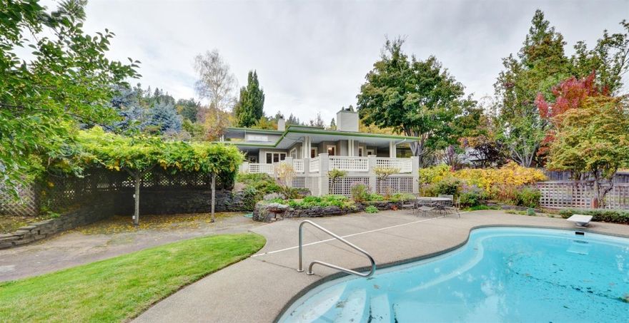 A true gem! Bright and wonderful custom Craftsman style home, on nicely landscaped .43 acre flag lot. Enjoy outdoor living with an in-ground pool, multiple decks and patio areas. This well-lit home features hardwood floors, gas fireplaces, skylights, and built-in cabinetry. Relaxing living room with fireplace is surrounded by the wrap-around deck. Dine at the breakfast bar and nook in the kitchen, or in the formal dining room. The lower level has two bedrooms, two bathrooms, while the upper master suite offers a gas fireplace, two walk-in closets, two master bathrooms and a spacious balcony. New paint on large deck and interior; new carpet. Spacious laundry room with utility sink, and plenty of storage throughout. Must tour to appreciate!