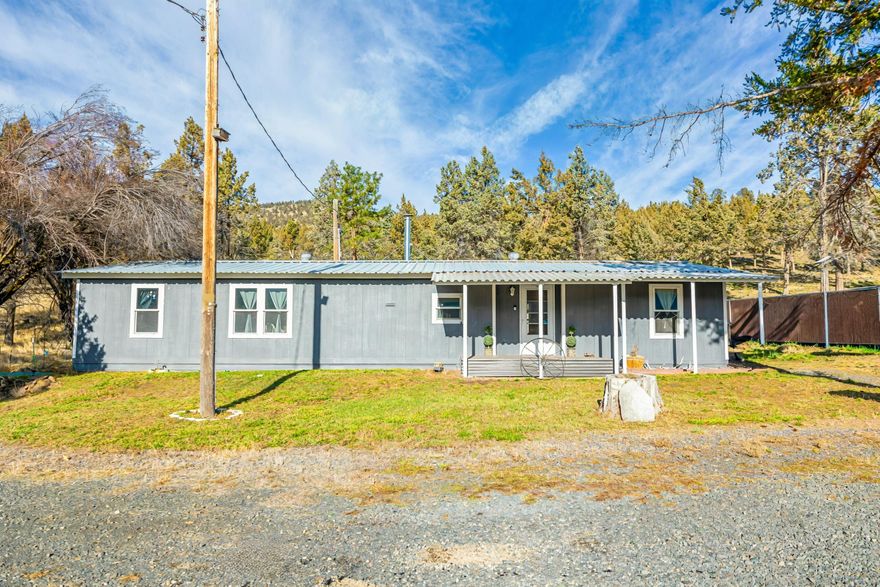 Beautiful 9.85-acre fully fenced property just minutes from town. This turn-key country retreat features a newly renovated manufactured home with fresh updates throughout. A private gated entrance leads to open, usable acreage with multiple outbuildings offering excellent storage, workshop, or hobby space and is also backed by over 2,300 acres of BLM land for additional privacy.

Property includes a private well and septic system, providing added independence and lower utility costs. The land is ideal for livestock, gardening, and many more hobbies and lifestyles. Enjoy peaceful rural living with easy access to town amenities. Move-in ready and full of potential—this one is a must-see.