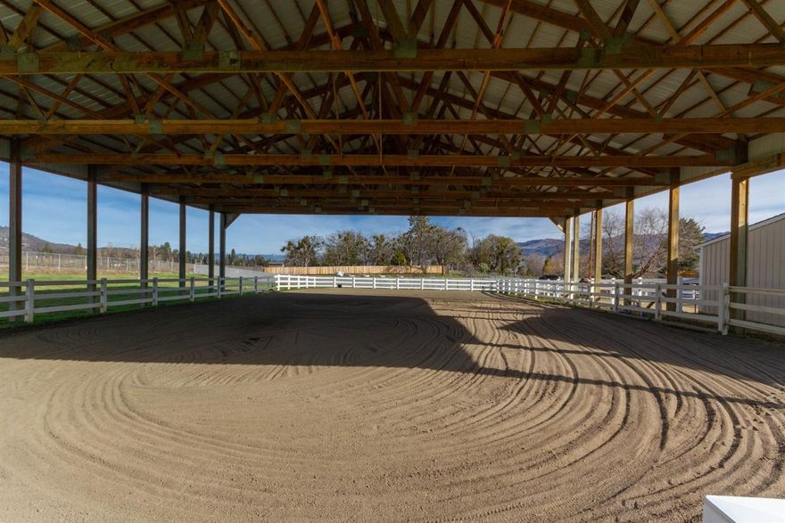 Exquisite horse property located minutes to downtown Talent and Ashland with views of the mountains and vineyards. This immaculate home has a remodeled kitchen with neutral granite, tiled floors, cabinet pullouts and stainless steel appliances. The kitchen opens to the 2nd family room with beautiful tiled wood burning fireplace and views of horses. The front living room has built ins, fireplace and has views of the mountains in a forest like setting. Solar tubes throughout the home add natural light. The master suite with sitting area, remodeled bath with tile work, skylights and huge walk in closet. A horse lover's dream with just over an acre that includes: 3 stall insulated barn with hay storage and 2 concrete floored tack rooms; an 84' x 66' sand filled covered arena; corral with electric cross fencing and a fenced pasture. There is also a 114' x 12' RV parking area, raised garden beds, firewood storage and 2 sheds. Finally, a peaceful backyard with a park like setting.