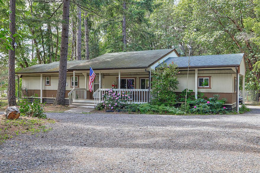 Tucked away in an enchanting, forested setting, this solid 2 bedroom, 2 bath single-wide manufactured home together with a professionally built addition, offers 1158 sq ft of living space, new double pane atrium windows, with a cozy wood stove and a 1500 sq/ft shop.  Beautiful, flat 2.88 acre property even has a seasonal creek that provides a natural cushion of peace and privacy from neighbors.