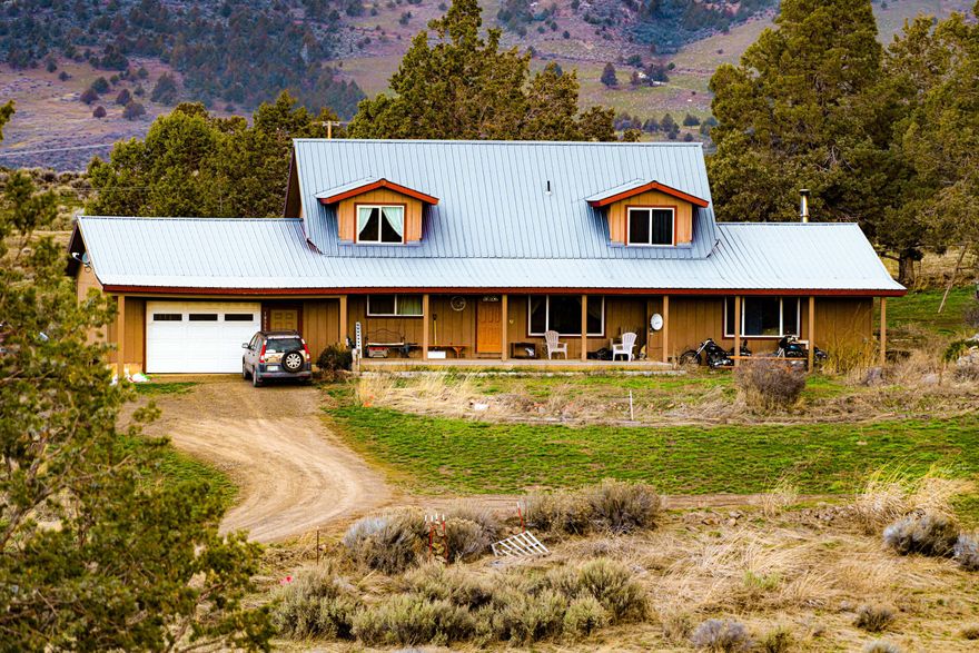 Looking for self-sufficient country living at its best? You found the right place! This tastefully remodeled home has it all. Features include a living and family room, office, formal dining, and primary with large walk-in closet, walk-in shower, tub and a bidet, Large country kitchen with island, stainless appliances, pantry and abundance of custom cabinetry. Main level also has a bedroom, half bath and office space. Upstairs has 2 bedrooms, full bath, and office set up with Starlink for remote work. Extra features include certified Blaze King wood stove, Allure floating floor, heated garage, and integrated backup generator. Exterior features include shop, wood shed, chicken coop, horse barn, greenhouse, fenced garden, pig pen, play structure, and insulated pump house with shelving for storage. Relax on the porch swing and enjoy the landscape and views. On clear nights gaze at the Milky Way as you appreciate the peace and privacy this amazing 21-acre property offers. Call now to see!