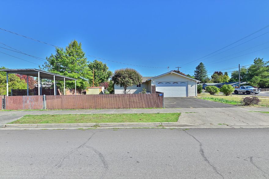 Location, location, location! Looking for a move-in ready home in the heart of East Medford w/ ample parking? If so, this is the one for you! This charmer features 3 bedrooms, 1 bathroom, 1,050 sq ft, spacious 0.3 acre corner lot, galley kitchen, newer HVAC system, new plumbing. The home has an automated sprinkler system in the front and backyard areas, attached 2 car garage, RV carport, and much more! Hardwood flooring underneath the carpeting provides an opportunity to bring back the original charm. Fireplace gas insert provides a nice ambiance as well as an additional heat source to the living area. This beautiful home has so much to offer at such an inexpensive price, so contact your agent today, before it's too late!