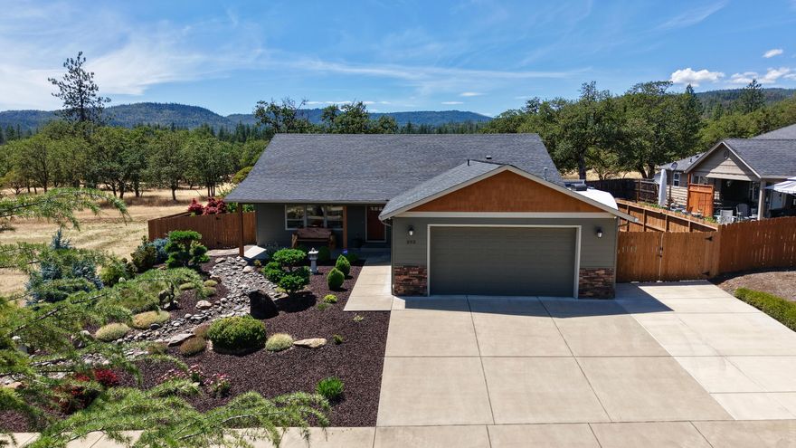 Experience quality and comfort in this beautifully crafted 3-bedroom, 2-bathroom home built in 2015 by Gifford Homes LLC. Offering 1,644 sq ft of refined living space, this residence features vaulted ceilings, granite countertops, custom cabinetry, a gas stove, pantry, and included refrigerator and reverse osmosis drinking water system. The elegant primary suite includes a walk-in closet and dual sinks. Additional highlights include a dedicated laundry room with washer and dryer, relaxing hot tub, sun blinds and an attached 30x24 finished garage. Outside, enjoy the fully fenced, level .23-acre lot with gated RV parking and a 10x12 Tuff Shed. Located near the scenic Rogue River with endless outdoor recreation nearby. HOA is $500/year and includes access to well-kept common areas. Connected to public sewer and a reliable Hiland Water, this home blends upscale finishes with convenience and outdoor living.