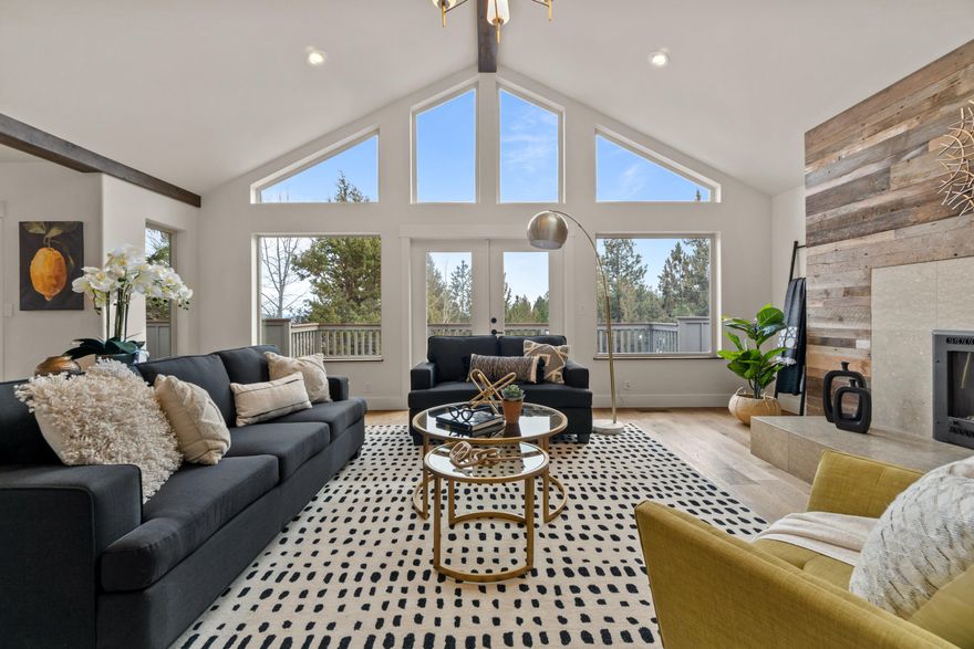 Exceptionally light and bright home with peek-a-boo easterly views! Located on a quiet street on Awbrey Butte the property is set on a spacious .57 acre lot. The home is an entertainers dream with soaring vaulted ceilings, beautiful stone and wood framed fireplace, and exposed wood beams in the great room.  Access to the expansive deck provided by two sets of french doors and a slider in the primary suite creates an easy flow from room to room. The kitchen features a center island and peninsula counter with stainless steel appliances. Recent upgrades include new interior and exterior paint, engineered hardwood floors on the main level, and new carpet downstairs.