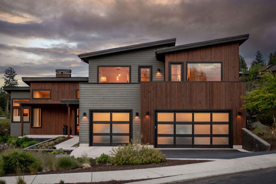 Clean lines and a fantastic floor plan! This stunning Tetherow home is situated on a corner lot and backs to Alpine Park for privacy and natural vegetation.  Cascade mountain and golf course views!
High ceilings and generous use of glass and windows for light.  Architectural detailing creates volume and incredible spaces with beautiful design touches.
Open, great room floor plan with large kitchen.
Primary on the main level and three en suites upstairs and a great Bonus room.
Wonderful incorporation of outdoor living spaces!  One upstairs deck off of the Bonus room with gas firepit overlooking the mountains and golf course, the other off the great room with fenced privacy, another gas firepit and hot tub.
Highly sought after Tetherow community with world class golf, fitness and incredible member facilities.