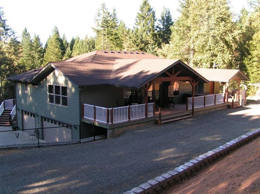 Gorgeous custom home on private setting with 4 bedrooms or 3+ bedrooms and an office with 3 full baths, 3550 sq ft custom built in 2007 on 5 beautiful acres with 3 car garage, wrap around deck, hardwood floors, granite in kitchen and bathrooms on main level, master suite on main level, with Jacuzzi tub and large shower in master bath, propane gas fireplace, Hickory cabinets in kitchen, with stainless steel appliances, separate sink in eating bar in kitchen, formal dining room, 2 heatpumps (1 up and 1 down), 1600 sf of composite decking & covered in several places. Down stairs can make great living quarters for guests or in-laws and has kitchenette. Property also has 1992 triple-wide w/1876+ sq ft that can be used for hardship and/or caretakers situation.