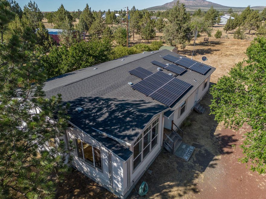 A DIAMOND-IN-THE-ROUGH!  This 2007 triple-wide manufactured home is ready for you to make it your own!  Home has been totally painted and ''spit-shined'' throughout the interior, which is in excellent condition, with coffered ceilings, floor to ceiling windows, ceiling fan., large pantry, kitchen island, family & living rooms. Carpet has been removed so that you can choose what appeals to you, whether it be hard surface flooring or carpet.  The home has solar, with last month's bill, being under $7.00.  The exterior needs new decks and the garage needs new overhead doors.  garage has stairs leading to mezzanine, for great storage.  Attached to garage is equipment storage and in addition there are 2 storage sheds.  This is a great investment and a way to gain some instant equity, with little elbow-grease!  Property is very close to the entrance of Crooked River Ranch, where you will find the warmest, most real place this side of the Cascades!  Visit, to see all our amenities!