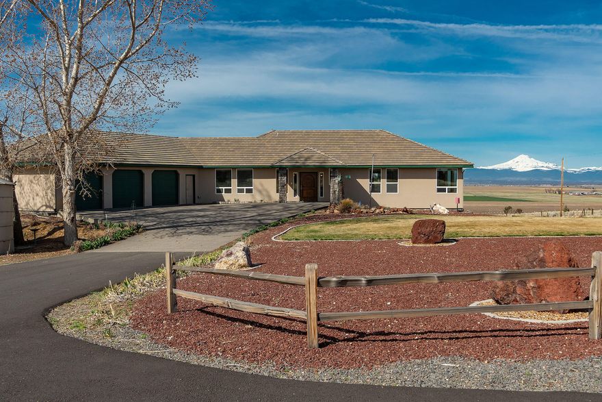 Amazing Horse Property with Stunning Mountain Views! Welcome to the best of farm life on this 33-acre estate, featuring 19 acres of irrigated water rights and breathtaking mountain views. This spacious 4,442 sq. ft. home offers versatile living with 2 bedrooms, 2 baths, and an  large office on the main level, plus a fully finished basement complete with 2 additional bedrooms, 1 bath, and a second full kitchen—perfect for multi-generational living or guest quarters. For those who need space, the 6,000 sq. ft. finished shop (100' x 60') boasts 12-14 ft. ceilings, a full RV hookup, and its own bathroom. Need more storage? A 2400 sqft covered shed provides ample space for hay, farm equipment, or recreational toys. With direct access to National Grassland, this property is ideal for horse enthusiasts, ranchers, or anyone seeking a peaceful rural retreat. Conveniently located just 15 minutes from both Terrebonne and Madras, you get the best of country living with easy access to town.