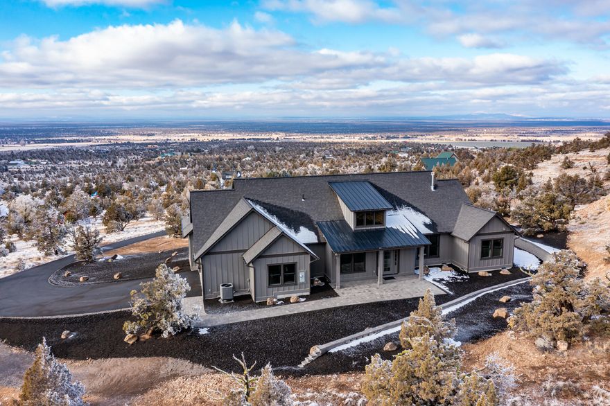 This is the legacy property one dreams about. The custom one-story home boasts 3 bedrooms, 2 1/2 baths and sits on a 5.17+/- acre property with panoramic Cascade Mountain views. The open floor plan has a stunning floor to ceiling tile fireplace, a gourmet kitchen with a 10-foot waterfall island, a dining area, office space, barn door pantry with beverage bar, powder room and a two-car garage with storage space. The primary suite which is separated from the other two guest bedrooms has a beautiful solid glass shower, a soaking tub and a spacious walk-in closet that opens to a large laundry room.  Not to be overshadowed is the covered paver patio where you will want to watch the sun go down and see the city lights of Bend at night. This one of kind property checks all the boxes off with an asphalt driveway, beautiful wood cabinetry, Calcutta laza countertops, modern lighting and designer touches throughout. This is your opportunity to live life as you always imagined in Central Oregon.