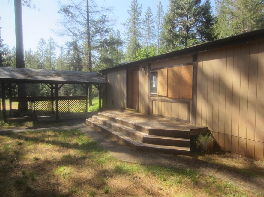 Nice wooded 5 acre parcel with a double wide 3 bedroom 2 bath, an inground pool, a large shop and a separate storage building.