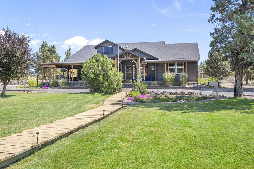 Escape to this beautiful 3-bedroom, 2.5-bathroom haven on 4.7 acres of serene, park-like land, just minutes from vibrant Bend. Rural yet less than 2 miles from Costco and with easy parkway access, this home offers peace and privacy in a tranquil country setting. Step inside to a warm, inviting interior built for comfort and functionality. Enjoy solar panels that slash power bills to $40-$100 year-round, even running heat sources and summer pumps. No annual sewer costs thanks to the septic and drain field. Irrigated green spaces thrive with water rights at under $1,000 annually. The property boasts a large detached workshop, dedicated art studio—perfect for creators or hobbyists—ample storage, a pull-through driveway, and a charming irrigation pond for unmatched scenic beauty. Relax on the covered porch amid nature's calm, with whispers of wind and wildlife. Ideal for a quiet retreat with space to grow, this gem blends rural charm with modern perks. Schedule your tour today!