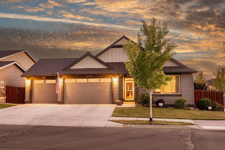 This turnkey, single-level home features a popular floor plan on a corner lot. The grand entry boasts a 12-foot coffered ceiling, leading to an open great room filled with natural light from high vaults, skylights, and tall windows, ideal for relaxation and entertaining. The kitchen includes a large quartz island with an eating bar. Upgraded tile flooring in bathrooms, new wood laminate flooring, stove, window treatments, air purifier, and a whole-house generator. The spacious primary suite has double coffered ceilings, access to a covered patio, a stylish tile-surround soaking tub, a separate shower, and a walk-in closet. The guest suite offers a view of Barnes Butte. The extensively landscaped yard features covered patio for beautiful sunset views and is conveniently located steps from a trailhead leading to 600 acres of walking trails. Community amenities include a pool, playground, and basketball court, with the HOA covering front yard maintenance and access to these facilities.