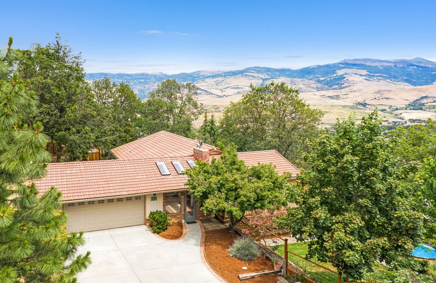 Versatile and spacious view home sited on an oversized 0.84 acre lot above Asante Ashland Community Hospital. Main level features three bedrooms and two full bathrooms including a master suite with dual vanity and walk-in closet, access to a recently rebuilt ~600 SqFt deck with incredible views of Grizzly Peak, walls of windows in a remodeled open-concept great room, renovated kitchen, stainless electric appliances, and pantry, along with a charming enclosed front porch, and two car garage. The lower level has three additional bedrooms, full bathroom, family room wood burning stove, separate exterior access, laundry, and storage area/mechanical room. Additional recent improvements include new laminate and tile flooring, bathroom vanity, quartzite counters, and all new light fixtures. Fully fenced and terraced grounds with TID irrigation rights, mature landscaping, fruit trees, and sunny gardening areas!