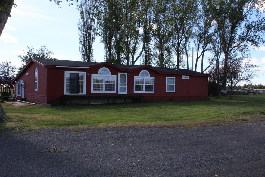 Enjoy the beautiful views of Langell Valley in this 4 bedroom, 3 bath Manufactured Home. This home sits on 67 acres with 66 pasture acres that are flood irrigated. Home has an open floor plan with a very large bonus/great room that is not included in the sq ft. A new 50 yr roof was installed in 2016 which has a one-time transferable warranty. Other features include: all new skylights, pellet stove, breakfast bar, large laundry and mud room, covered deck, and nice neutral colors. Property includes corrals; pen; a large hay barn with a loft for storage; nice shop with concrete floor, work benches and power; grain storage with an auger; old grain shed used for a tack room; and a charming old homestead dating back to 1898. Cattle panels and squeeze chute excluded.New Septic tank installed 5/2018.