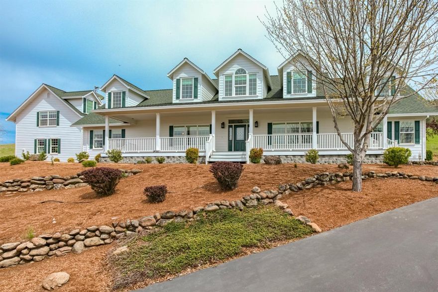 This gated home offers an abundance of natural light to showcase the spacious kitchen, vaulted dining room and open living room with large stone fireplace. So much detail was involved in the designing of this 4 bedroom, 3 bath home, including the permitted additional living quarters upstairs above the garage/shop. Upstairs living space offers kitchen and full bath, laminate flooring and exceptional views of the valley. Large porch in front and back of the home. Master suite is separate from other bedrooms. This home offers so much. Furniture is available to purchase outside of sales agreement.