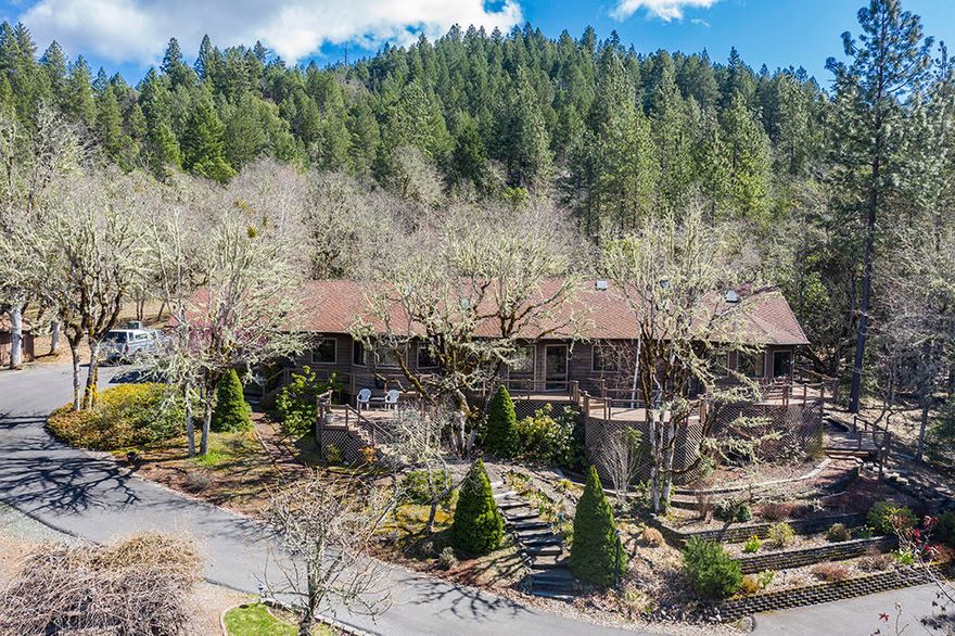 Amazing Custom Home on 6.48 acres in the Shadow Hills Neighborhood. This home features 3 Bedrooms, 2 1/2 Baths, Office/4th Bedroom, 2415 Sq Ft, and Beautiful Views from every room. Large Kitchen with Huge Island, Lots of Storage & room for the whole family. French Doors will take you to the Beautifully Planted back yard and Patio. Large Master Suite has Vaulted Ceilings, Bay Window, Beautifully Remodeled bath with Spa Tub, Double Sinks, Huge Shower, & Walk in closet. 3rd Bedroom is currently being used as a TV Room with French Door to the incredible multilevel deck with seating areas that wraps much of the house. The daylight basement has been converted into a Spectacular Wine Cellar with Gorgeous Redwood Wine Bar, Kitchenette & racks for all of your favorite wines. You'll love the 960 Sq Ft detached Shop/Garage with Full Bath, Laundry & RV Parking with Hookups. There's also a Large fully fenced Garden with Raised Beds, Irrigation & many Fruit Trees.