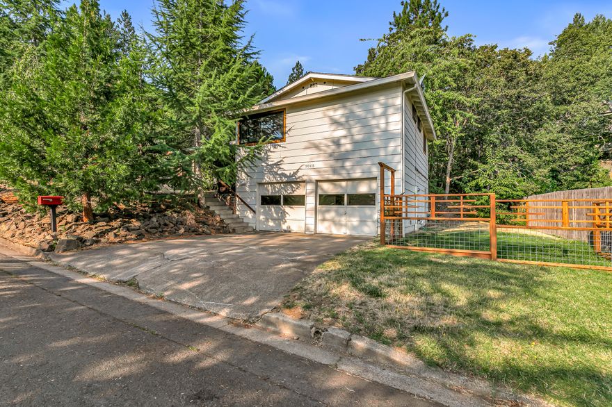 Charming home with treehouse-like feel on a spacious corner lot with mature trees in a desirable and centrally-located neighborhood above the boulevard! Abundant natural light and air-flow with new operable Anderson windows, new attic and subfloor insulation, and new roof since 2018. All living areas on the main level with tiled entry, coat closet, and laminate flooring throughout living, family, dining, kitchen, and three bedrooms. Kitchen with dining counter, new refrigerator, four-burner electric range oven, dishwasher, and double sink overlooking side yard. Dining with French doors to covered back patio; adjacent family room and wood-burning fireplace with brick hearth. Primary with walk-in closet and full ensuite bath with tiled shower, second bedroom with built-in shelving and closet, third bedroom with built-in wardrobe, and full guest bath with tub shower. Lower laundry with washer, dryer, utility sink, and two-car garage with storage and workbench. Inquire for details!