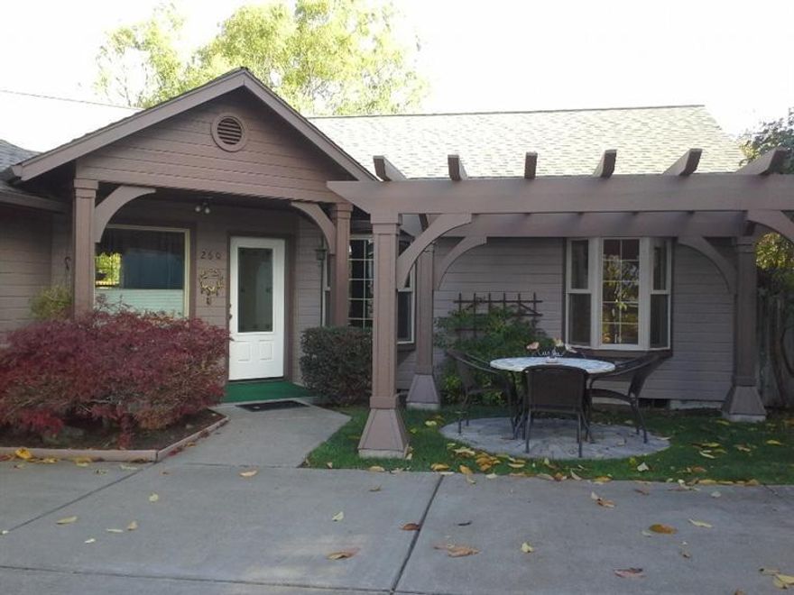 This lovely single level contemporary home features a high vaulted cathedral ceiling in the living/dining room, with gas fireplace and built in bookshelves, plus skylights for extra light. The master bedroom is vaulted with a newly remodeled master bath, with granite countertops, custom sinks, built in shelves and walk in tub. The master also has an electric corner fireplace for ambiance, custom windows, ceiling fan and two sets of closets. The other two bedrooms have been customized to include larger bay windows. The second bath has been remodeled with a new pedestal sink, and tile accents. Outside there's a custom Pergula patio area with decorative bricks. The backyard has raised beds, a fountain, shed and water catchment system. This is a beautiful place to call home!