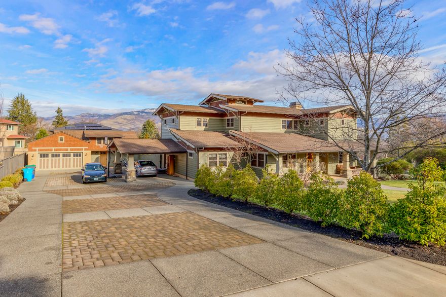 Top quality materials coupled with an artistic flair, this custom built Craftsman style home exudes warmth and charm throughout. Main home features 5 beds, 3 baths and over 4,000 SF. There is also a 475+ SF detached guest space for overflow living. Gourmet kitchen with vertical grain Fir cabinets, Corian countertops, tile backsplash + adjacent mudroom with sink and built-ins. Master Suite offers balcony views, high ceiling, heated tile bathroom floor, 2 person jetted tub + 2-headed shower; walk-in closets in all three upstairs bedrooms. Versatile, finished basement for hanging out, working from home or both. Main level library + formal living room w/ fireplace. Outdoor entertaining is a dream; expansive hardscaping, stone patio with seating wall, newer deck with sunken hot tub, paver driveway, small orchard and usable .50 acre lot complete with TID irrigation. Detached 715 SF, garage with ample storage. Expansive views of Grizzly Peak and close proximity to town.