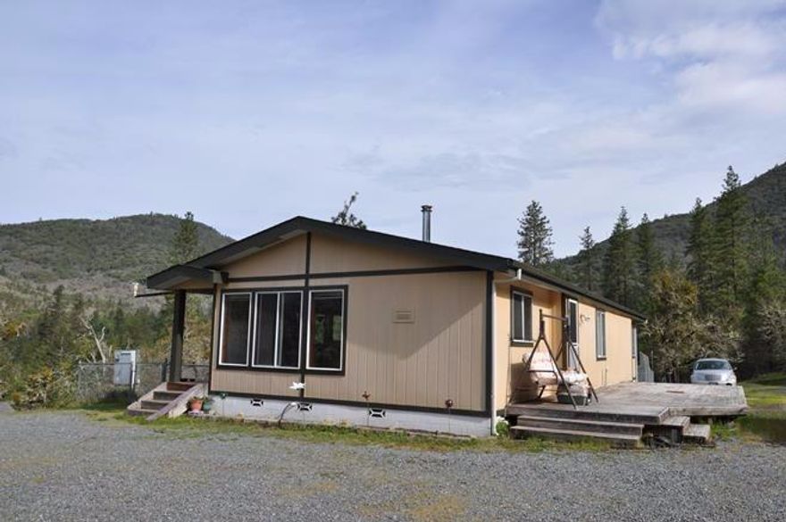 A little piece of paradise with fantastic views. The home sits close to the end of the road on a knoll that gives views in several directions and then is backed by BLM for privacy. There is a circular driveway for easy access. Located a short distance from the home is a hobby barn with stalls, chicken coop, tack room and potentially covered RV parking with hookups & septic dump. Great water (per well log) and sun with pastures and garden area. Home needs a little TLC but has 3 bedrooms, 2 baths and again beautiful views.