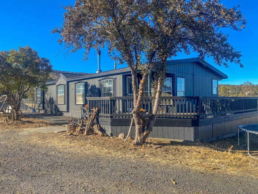 Lots of updates done to this home on almost 2 acres with a large shop. Home has bamboo flooring throughout, office with french doors could easily be an additional bedroom, updated kitchen with tile backsplash and island with butcher block countertop, new interior and exterior paint, new roof and large deck. Shop has two roll up doors, concrete floor, power and is plumbed for a bathroom that has not been completed.  The two story structure is approximately 200 sq ft per level with exterior access only, could be additional living or storage space or could easily be removed. Animals allowed.