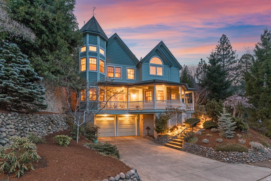 Custom Victorian home in Ashland Historic District, designed and built by Carlos Reichenshammer,  just blocks from Lithia Park. Marble floor entry to formal living room has vaulted ceiling, plush bench seating and fireplace. Enjoy entertaining in formal dining room with built in cabinetry. Huge country French kitchen boasts granite countertops, two islands, Thermadore 5 burner cooktop, double Bosch ovens and glass paned cabinets. Kitchen opens to family room with fireplace and breakfast nook. Majestic oak stairway leads to office/library and guest bedroom with walk-in closet and en suite bath. Primary suite has fireplace,2 walk in closets and bathroom with soaking tub and shower. Mountain views throughout. Custom 650 bottle wine cellar features travertine walls and floors. Courtyard water fountain, large front wrap around porch and back deck complete the outdoor amenities