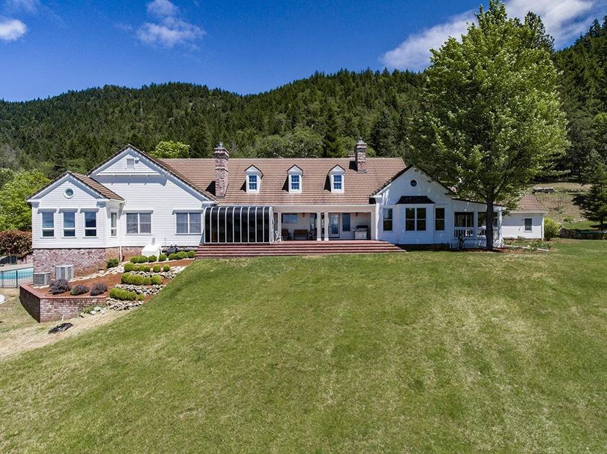 Spring Mountain Ranch, one of the most unique and beautiful estate type properties in Josephine county. 207 ac gated, basically your own private valley in the north foothills of Grants Pass. Spectacular views and it's just minutes from town. Custom built in 1987, this Williamsburg styled country estate type home features 5 bedrooms, 4.5 baths, approx. 6442 sf, formal living room with vaulted ceilings and fireplace, gourmet kitchen has 6 burner range with double oven, island, hearth room with another fireplace, main floor master with fireplace and attached sunroom, huge family room with incredible bar, 3 heat pumps, central vacuum, loads of storage, generator, 3 car garage, screened in porch, sunroom/spa room, tile roof, painted redwood siding, in-ground pool, 2nd residence is approx. 1600 sf, 3 ponds, 36X40 shop and 4 stall barn both heated, 2 rented radio/tv towers, paved driveway with security gate and adjacent to BLM. Truly a one of a kind estate. Buyer to do all own due diligence