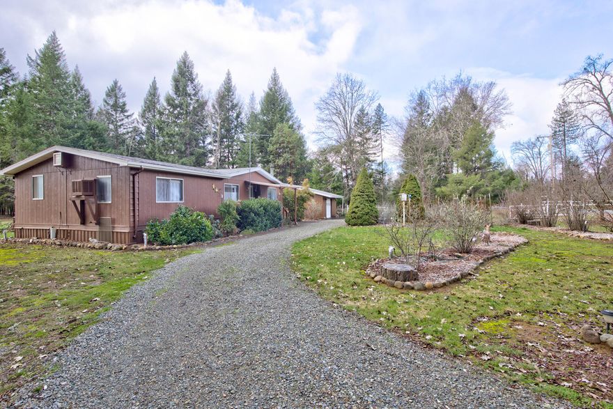 Country living on a quiet road in the heart of the Illinois Valley. Set up your hobby farm here! Excellent well (50 gallons a minute when drilled). Flat, usable, 1.99 acres with lots of room for gardening – there's already some raised beds, fruity trees, and ornamental shrubs and other plants. Property is fenced and cross fenced. Several outbuildings, including a two-car garage with shop. Three bedroom/two bath home is cozy, clean, and great condition. All appliances stay!