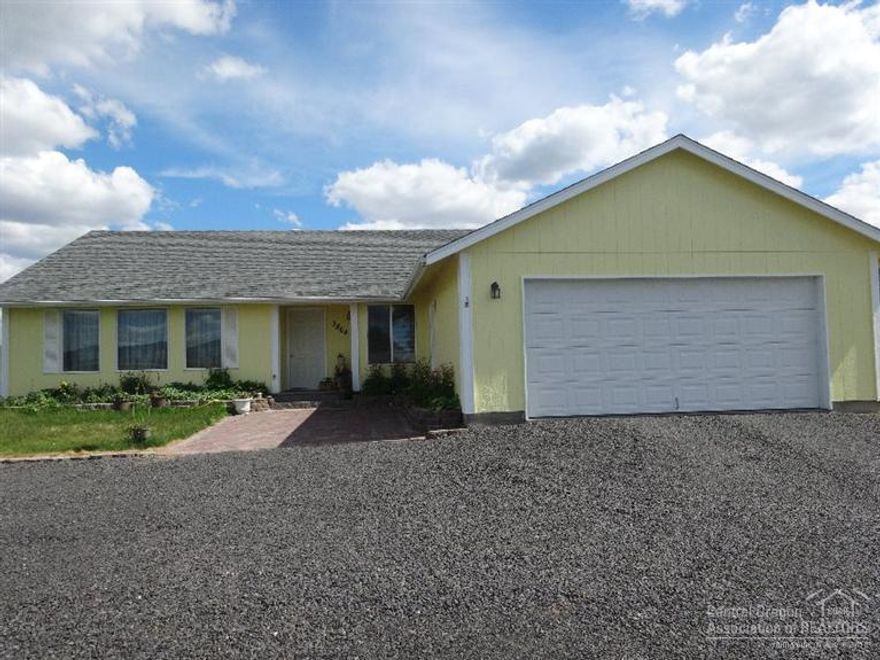 Well maintained home, minutes from town, built in 2006 on 4.8 acres with 4 acres of irrigation. Great for 4H animals. New interior & exterior paint. Home has 1828 sq.ft. w/ 4 bedrooms, 2 bath. Vaulted ceilings, new carpet throughout Skylight in the kitchen makes it open and light. Ceramic propane stove in living room w/thermostat. Property is totally fenced. Circular drive. Large yard. Fruit trees & raised bed garden and lots of flowers. Wetlands Park across the street will prevent future building.