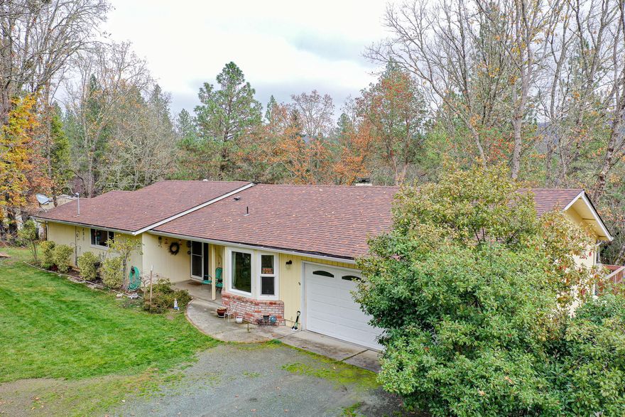 Ranch style home overlooking your own corner of wooded splendor, with a deck to enjoy the outdoors, an established garden area and fruit trees. Besides 2 very spacious bedrooms, you'll find these bonus rooms: a craft room off the living room, which could be a 3rd bedroom and a room off the master bathroom that could be used for an office space or a small Childs room with a separate outside entrance. The kitchen has hickory cabinets and the dining room sports a bay window. You'll have end of the road quiet and a trail to walk through your woods