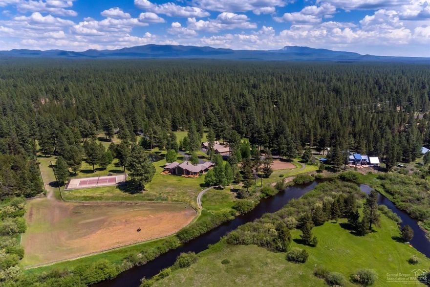 Little Deschutes Riverfront Equestrian Estate with Mt. Bachelor Views. Custom Sun Forest Home is NW Style, 3288 sf with an open floorpan, vaulted ceilings with wood beams, custom features throughout the home. The home features a gourmet kitchen with granite countertops, alder cabinets, SS appliances, pantry, master suite with jetted tub, deck access and fireplace, guest room, family room/possible 3rd bedroom, office and attached garage. The equestrian facilities: 7 stall insulated barn, tack room, wash rack, feed room, equipment storage, guest studio, outdoor arena 100x200, 3 pastures and round pen. The property includes: 12.1 acres with 3.75 acres of irrigation water rights with automatic sprinkler system, heart shaped pond, tennis court, gated entrance and public land across the street. This property offers privacy, trail and river access, mountain views and a wonderful opportunity to enjoy the Central Oregon lifestyle!