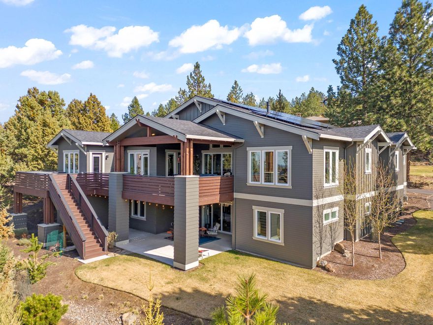 Nestled in the sought-after Awbrey Butte neighborhood, this stunning home seamlessly blends warmth, elegance, and a hint of moody sophistication. Perched on a spacious .58-acre lot, it offers breathtaking Cascade Mountain views from Mt. Bachelor to Mt. Adams. Designed for luxurious yet efficient living, this home features heated floors, a bonus room, theatre room, and two versatile flex rooms that provide ample space for hobbies, work, or extra storage. Energy-conscious buyers will appreciate the prestigious Gold Earth Advantage certification, a perfect home energy score of 10, and 55 solar panels for ultimate efficiency. The inviting interior showcases rich hardwood floors flowing into a chef's dream kitchen with high-end appliances. Step onto the expansive Trex deck, where a private hot tub awaits for stargazing and relaxation. An oversized 4-car garage ensures plenty of room for a work space, your recreational toys and more. Experience mountain living at its finest