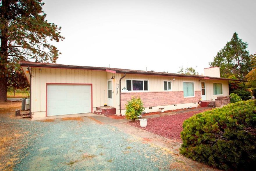 Have you dreamed of country living, but need to be close to town? This charming single level 1480 sq ft, 3 bedroom, 2 bath home is perfect for you! Sitting on .65 acres, RV parking with attached garage, separate shop, close to the hospital, RCC Redwood Campus, walking trails, grocery stores and minutes from downtown Grants Pass.