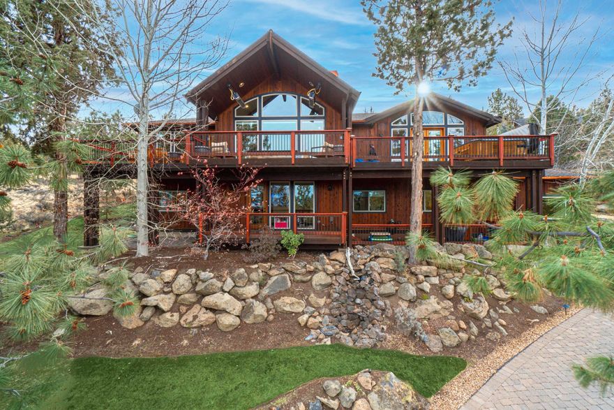 This gorgeous Awbrey Butte property offers stunning views of the Cascade Mountain range throughout this 3,881 sq ft home. With high ceilings and elegant wood beams, this spectacular home is full of natural light. The main floor features an open floor plan with a spacious living area and rock fireplace, an amazing kitchen, granite countertops, a large island, breakfast bar, pantry, and dining area with glass doors leading to the partially covered upper deck. The master bedroom is bright and airy with a luxurious master bath. The downstairs offers a comfortable living area with wet bar, wine/storage cellar, a bonus office space, three bedrooms, three full bathrooms, laundry, and an oversized 3 car garage. With beautiful landscaping, a heated driveway, and astounding views, this exquisite property is a must-see!